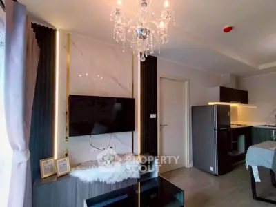 Modern living room with elegant chandelier and open kitchen layout