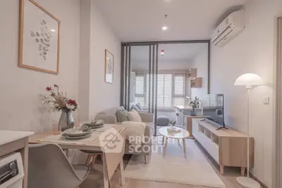 Modern living room with stylish decor and open layout, featuring cozy seating and natural light.