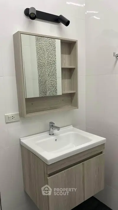 Modern bathroom with sleek vanity and mirror cabinet