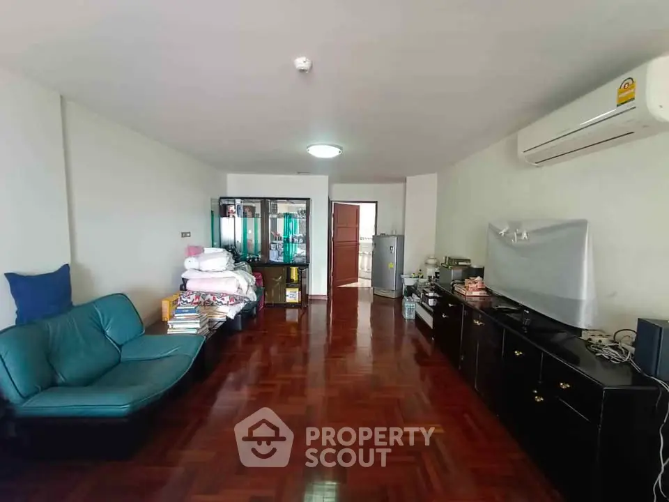 Spacious living room with wooden flooring and modern furniture