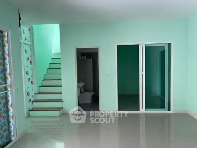 Spacious interior with modern staircase and sliding doors, ideal for contemporary living.
