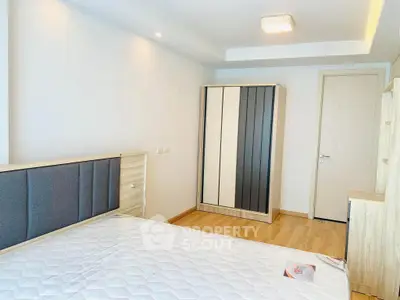 Modern bedroom with stylish wardrobe and cozy bed in bright apartment