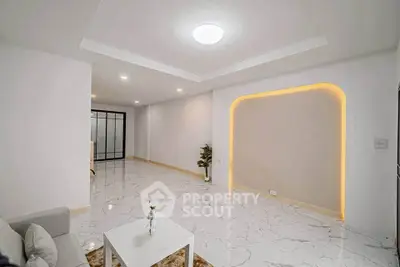 Spacious modern living room with elegant lighting and marble flooring