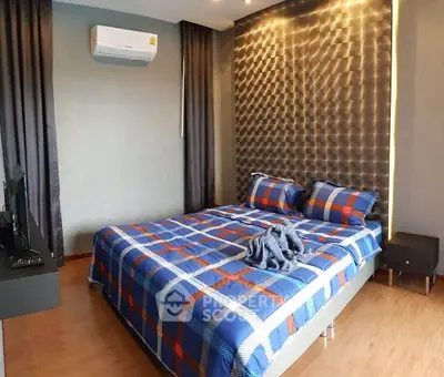 Modern bedroom with stylish accent wall and air conditioning, featuring a cozy bed with plaid bedding.