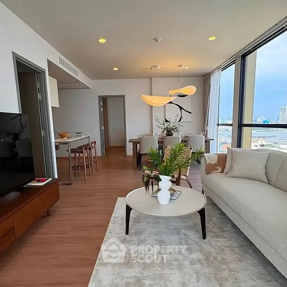 Spacious modern living room with open layout and stunning city view