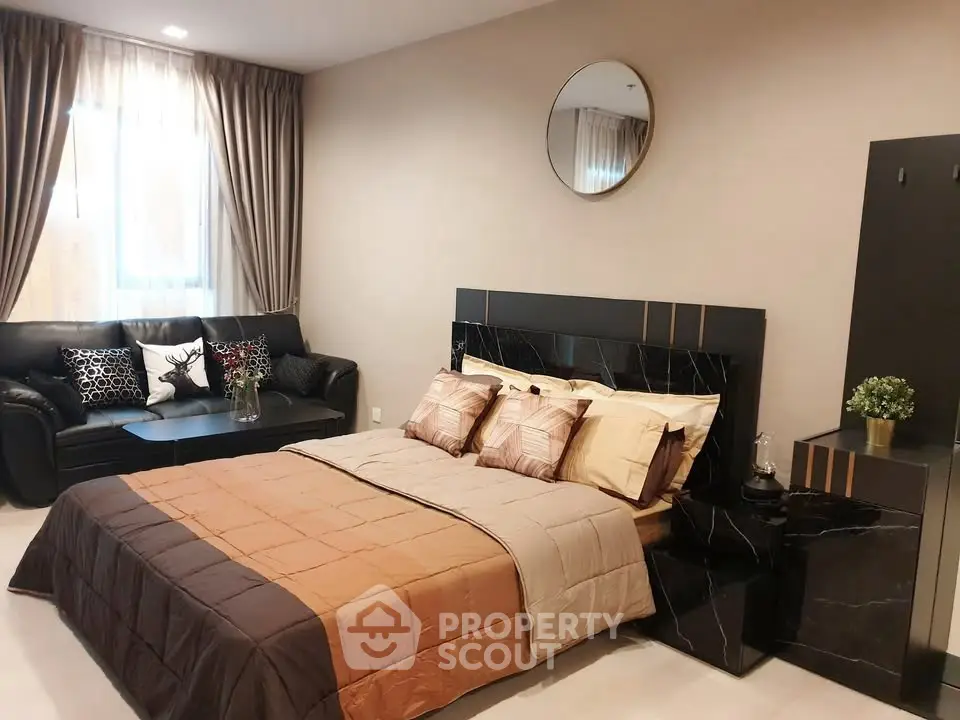 Luxurious bedroom with elegant decor and cozy seating area, perfect for relaxation and comfort.
