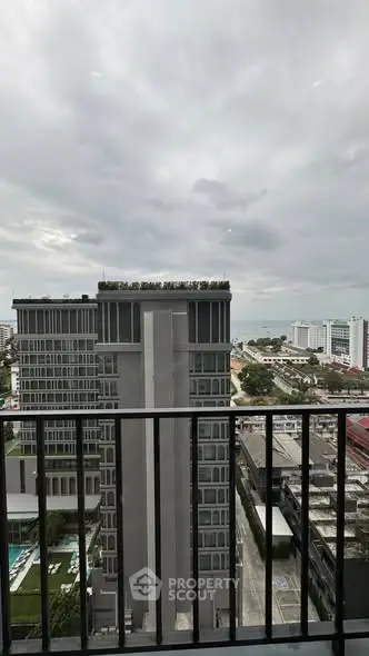 Stunning cityscape view from a high-rise balcony with modern architecture.