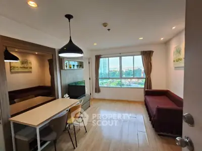 Modern living room with large window and stylish dining area in a cozy apartment.
