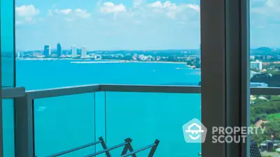 Stunning ocean view from a modern balcony in a high-rise apartment.