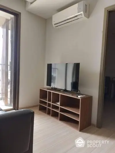 Modern living room with sleek TV setup and air conditioning