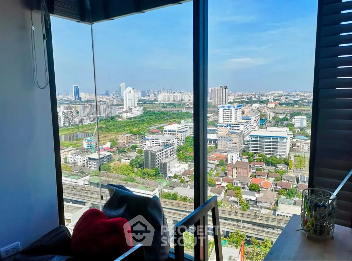 Stunning cityscape view from a modern high-rise apartment window, showcasing urban living at its finest.