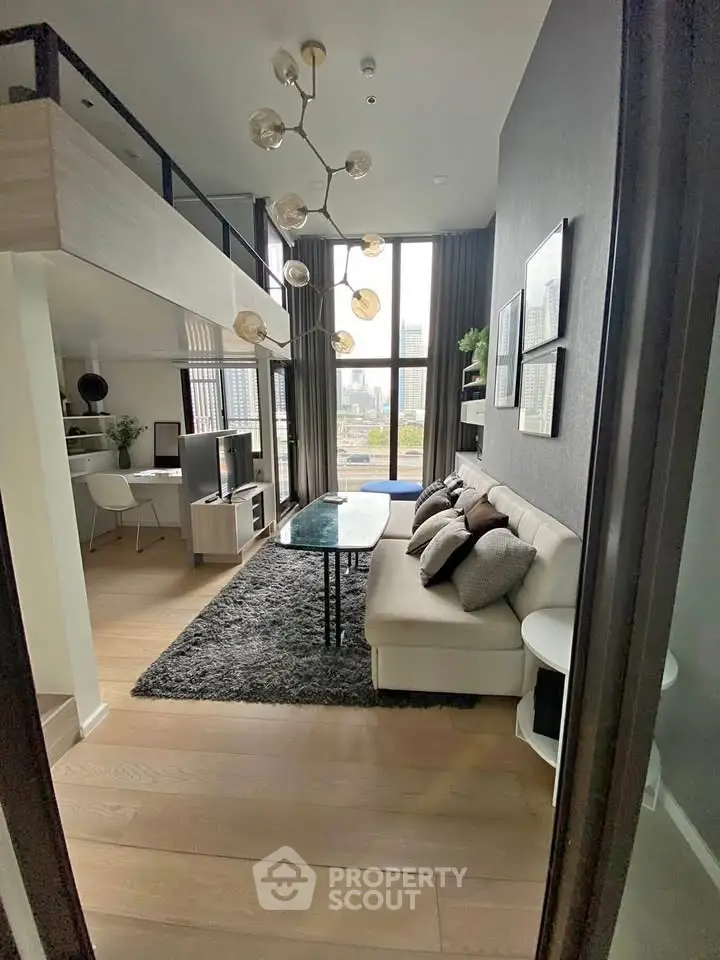 Modern loft-style living room with high ceilings and large windows offering city views.