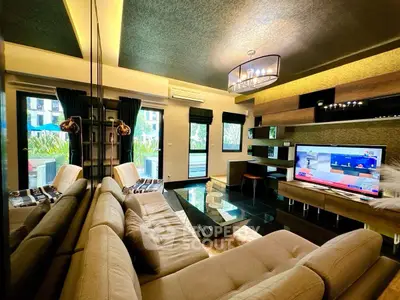 Luxurious modern living room with stylish decor and large windows offering garden views.