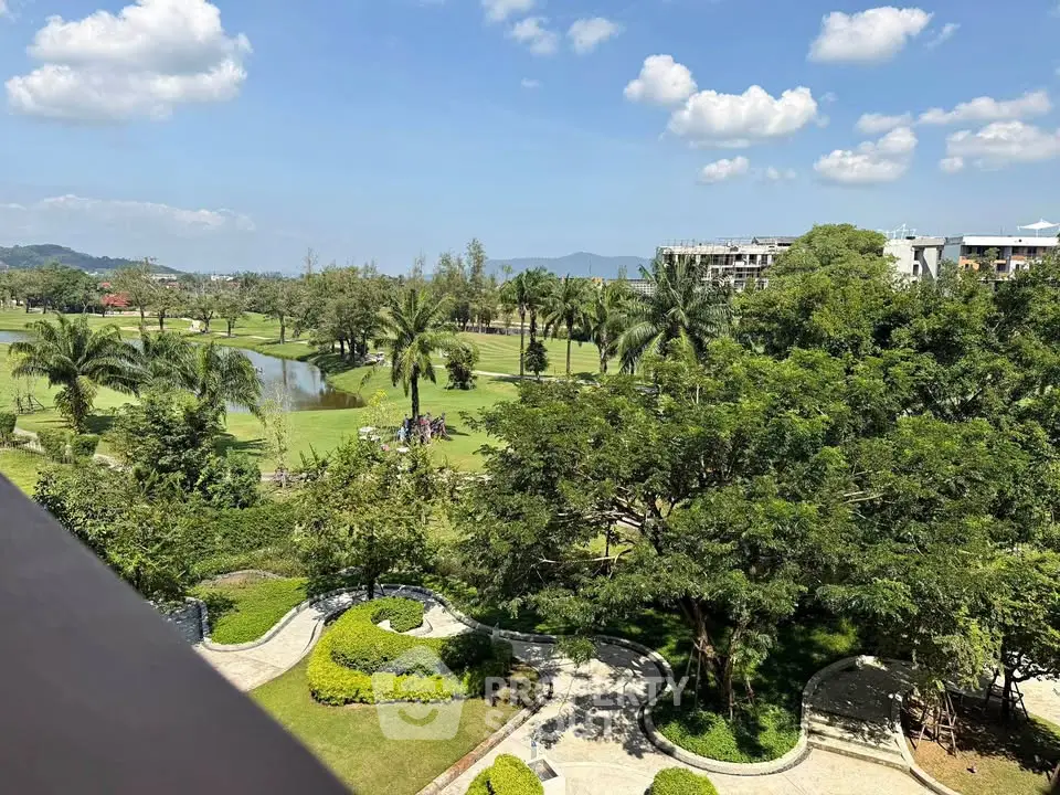 Stunning golf course view from a high-rise balcony with lush greenery and blue skies.