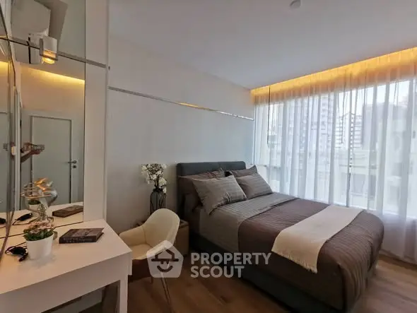 Modern bedroom with stylish decor and large window offering city view