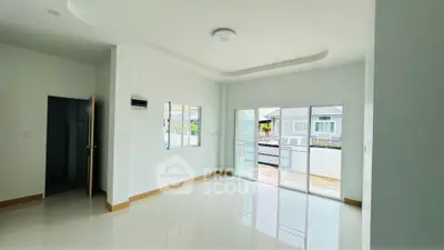 Spacious and bright living room with large windows and modern design.