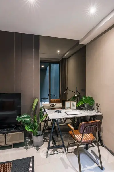 Modern study room with stylish desk and chair, indoor plants, and ambient lighting.
