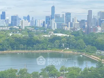 Stunning cityscape view with lush greenery and serene water body, perfect for urban living enthusiasts.
