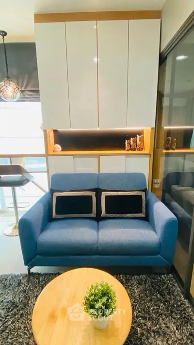 Modern living room with blue sofa and stylish decor