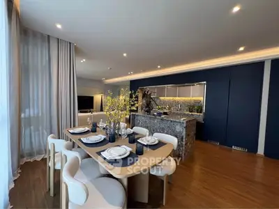 Luxurious open-plan living and dining area with elegant decor and modern kitchen.