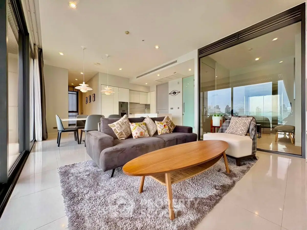 Spacious modern living room with open layout and city view, featuring elegant furniture and stylish decor.