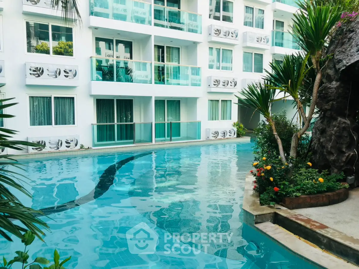 Luxurious apartment complex with stunning pool and lush greenery