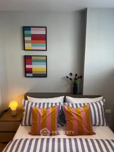 Stylish bedroom with colorful decor and modern artwork