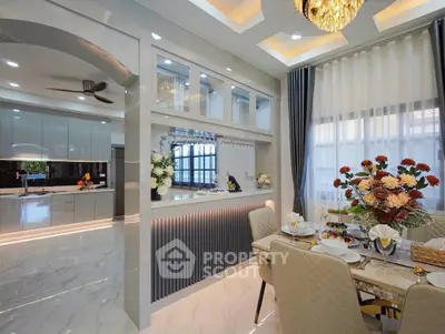 Luxurious dining area with elegant decor and modern kitchen in open layout design.