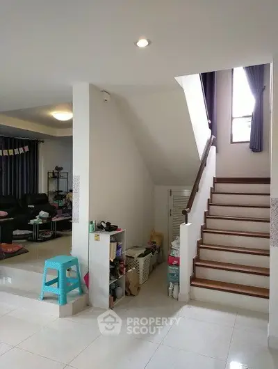 Spacious modern living area with staircase and stylish decor