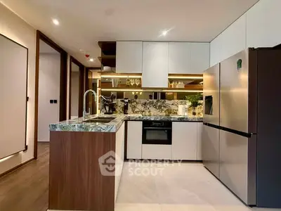 Modern kitchen with sleek design, marble countertops, and stainless steel appliances in a luxury apartment.
