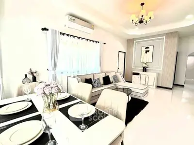 Elegant modern living room with stylish decor and dining area, featuring chic furniture and ambient lighting.