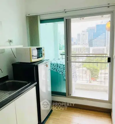 Modern kitchen with balcony view in urban apartment