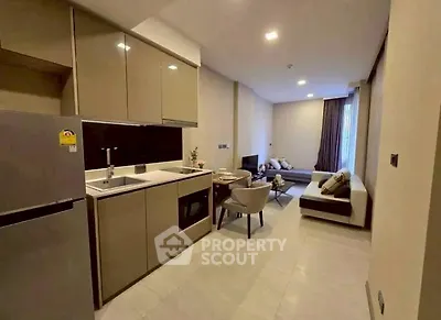 Modern open-plan kitchen and living room with sleek design and neutral tones.