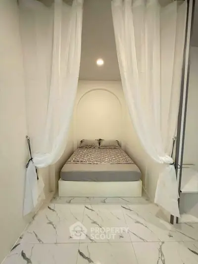 Elegant bedroom with marble flooring and canopy bed, perfect for a cozy retreat.