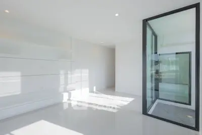 Spacious modern interior with large windows and sleek design, perfect for contemporary living.
