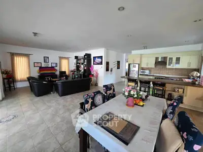 Spacious open-plan living and dining area with modern kitchen and stylish decor.