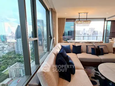 Luxurious corner unit living room with panoramic city view and elegant decor.