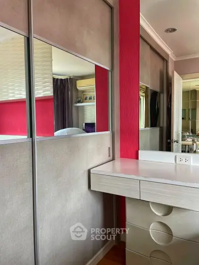 Modern bedroom with stylish wardrobe and vanity in vibrant colors