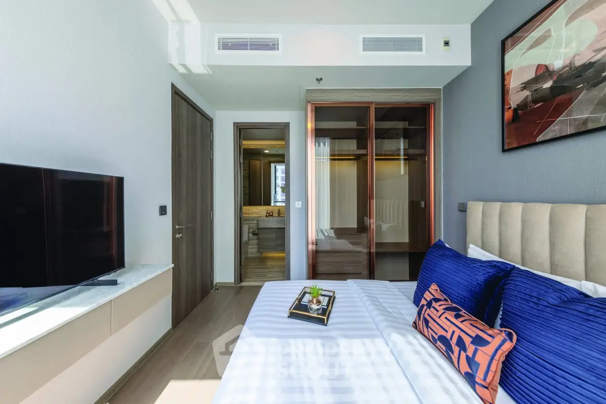 Modern bedroom with stylish decor and ensuite bathroom in luxury apartment