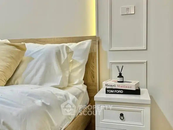 Elegant bedroom with stylish wooden bed and chic nightstand, perfect for modern living.