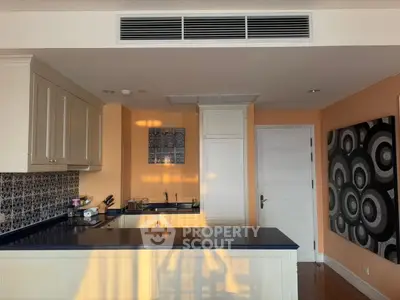 Stylish kitchen with modern design and closed layout, featuring sleek cabinetry and artistic wall decor.