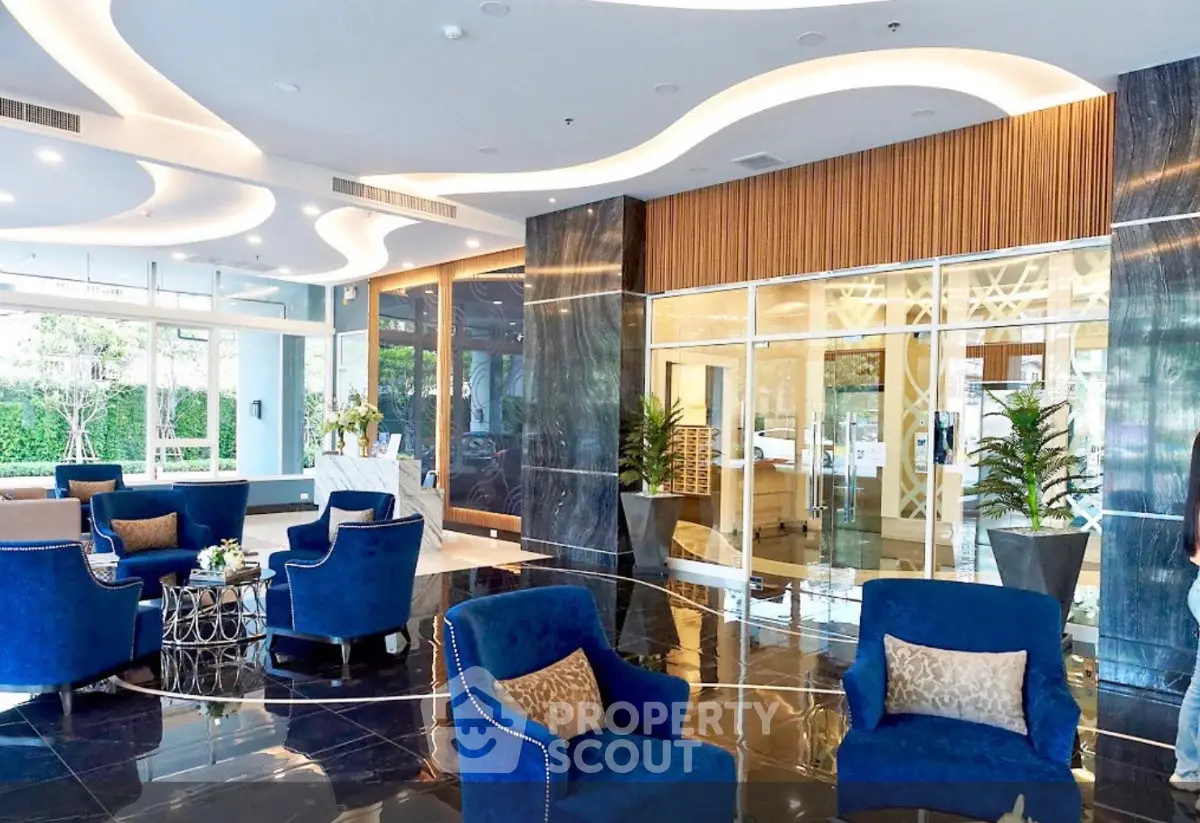 Luxurious modern lobby with elegant blue seating and sleek marble flooring