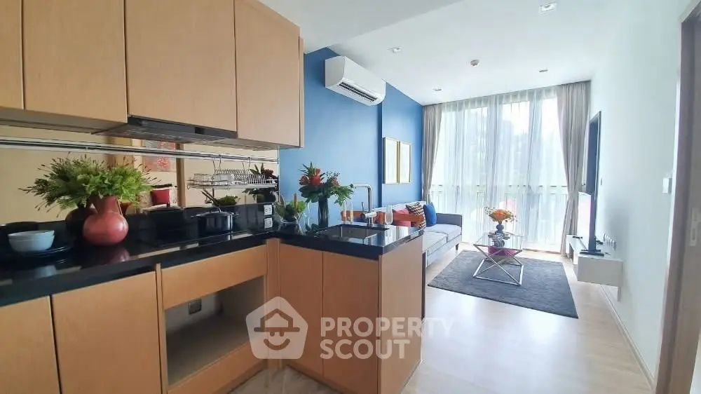 Modern open-plan kitchen and living room with stylish decor and natural light.