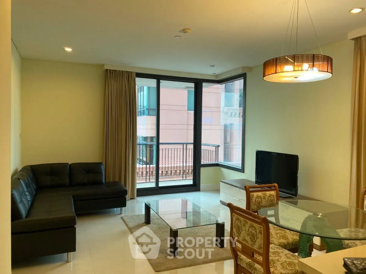 Modern living room with sleek furniture and large windows offering natural light.