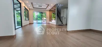 Spacious modern living room with wooden flooring and large windows