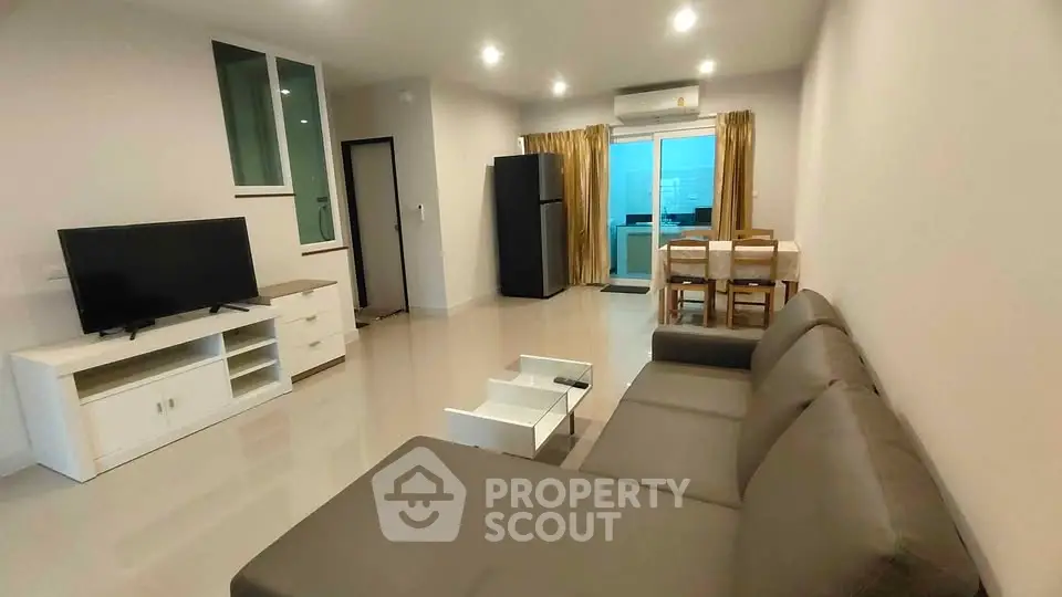Spacious modern living room with sleek furniture and open layout in a contemporary apartment.