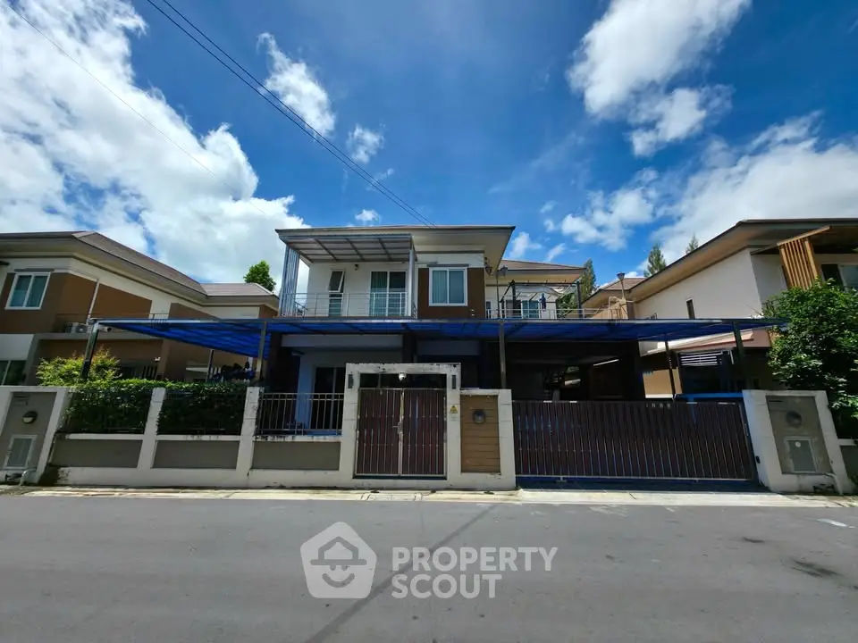 Modern two-story house with spacious driveway and blue sky backdrop