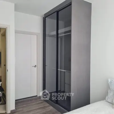 Modern bedroom with sleek sliding door wardrobe and minimalist design