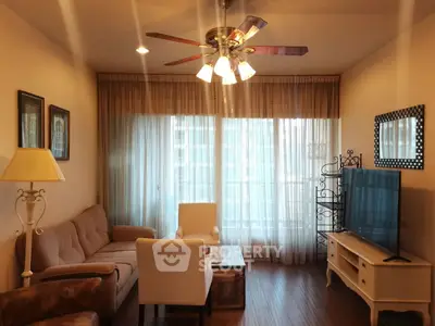 Cozy living room with elegant decor and large window for natural light.