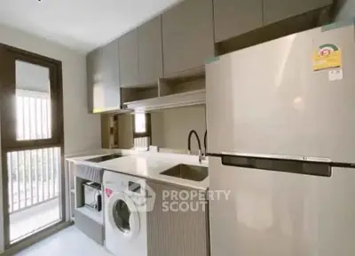 Modern kitchen with sleek appliances and ample storage space